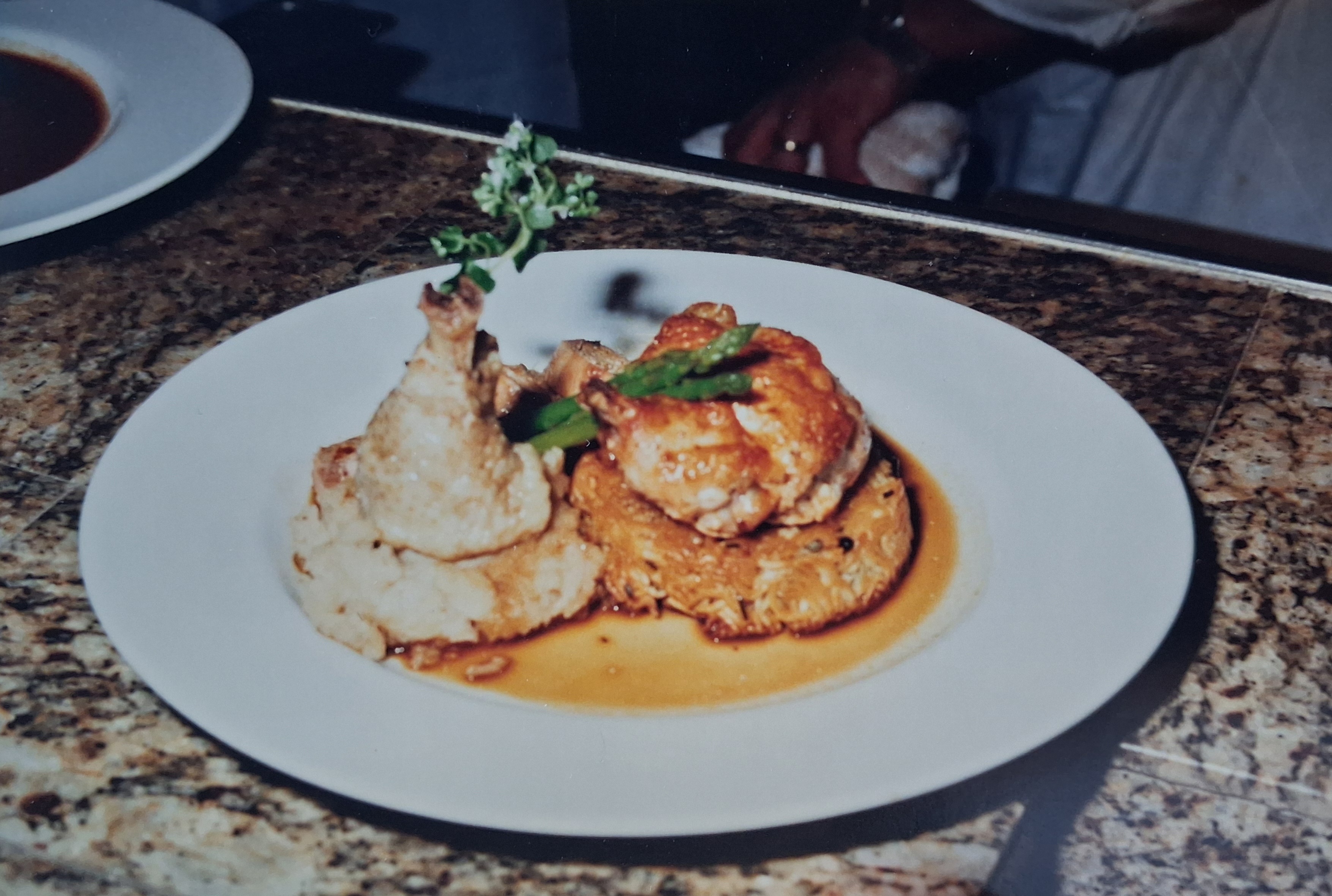 A plated roasted chicken dish.